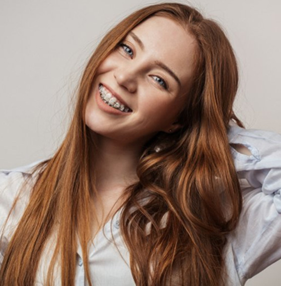 Teen with braces smiles