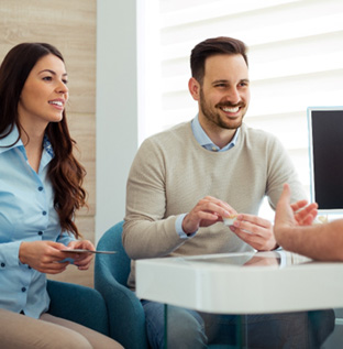 Dentist discusses matters with couple