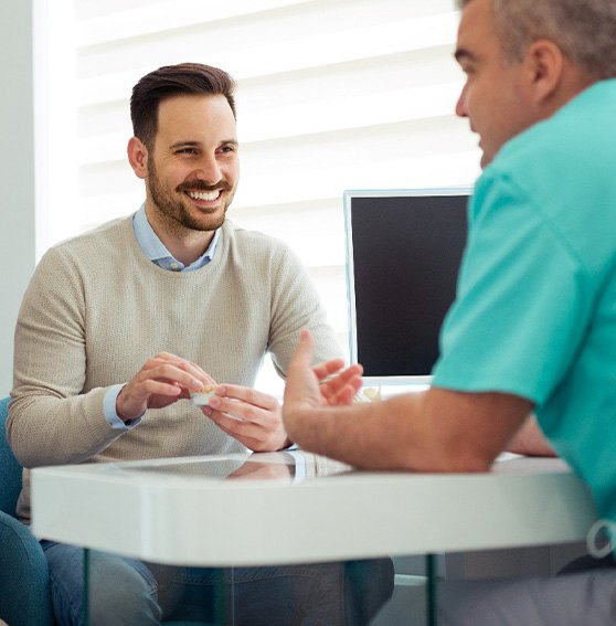 Couple discusses something with dentist