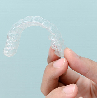 patient holding clear aligner