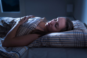 Woman with sleep apnea slumbering in bed