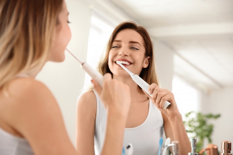 Patient brushing their teeth to prevent gum disease