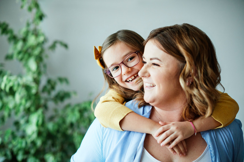 Patient smiling with child after frenectomy