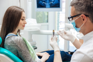 Patient and dentist consulting about dental implant treatment